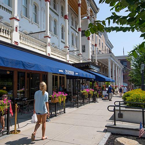 Woman walking down streets of Downtown Saratoga Springs looking into shops